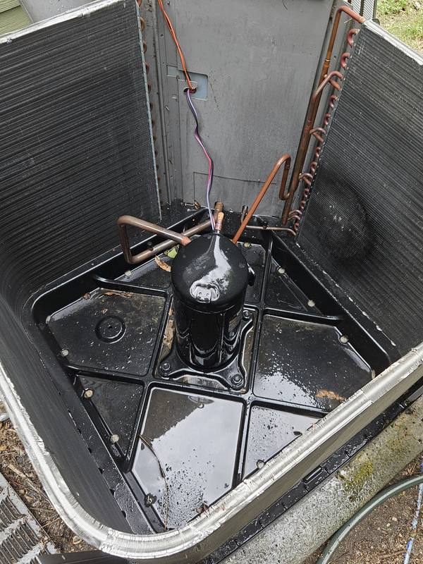 After: the same condenser base pan and compressor cleaned out