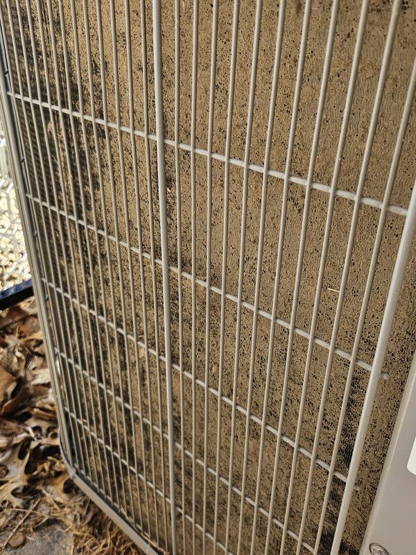 Before: outdoor condenser coil behind its wire guard, clogged with dirt and lint