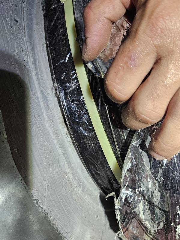 After: inner duct core re-attached with a zip strap and sealed with mastic